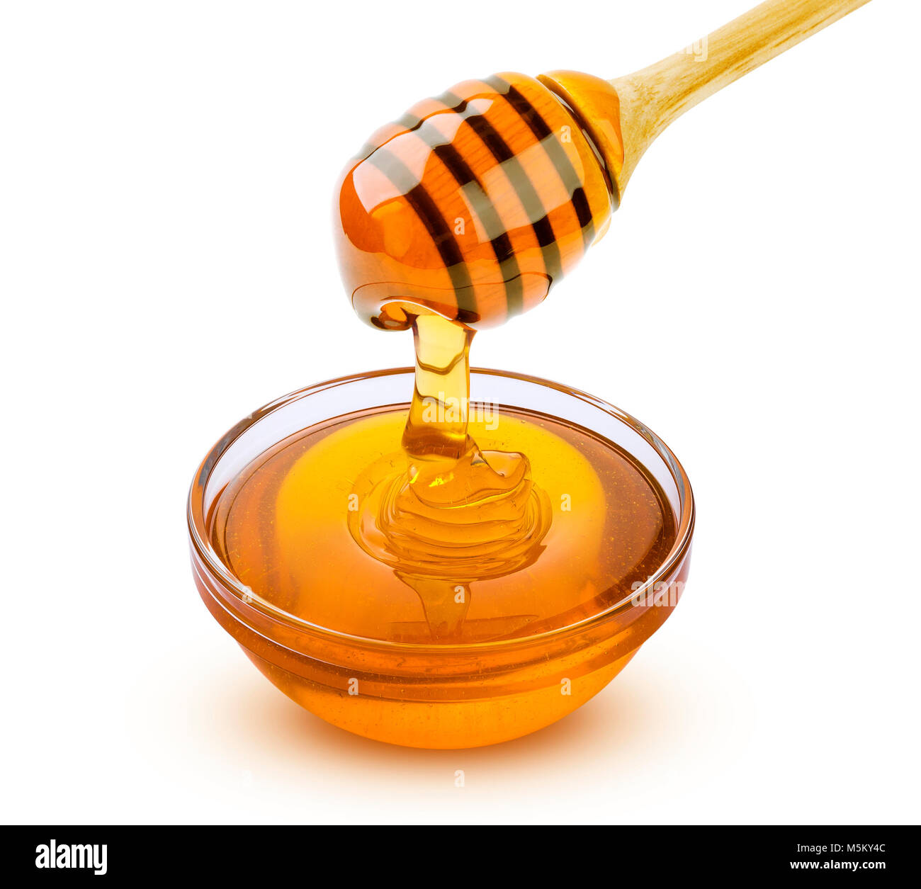Honey stick and bowl of pouring honey isolated on white background