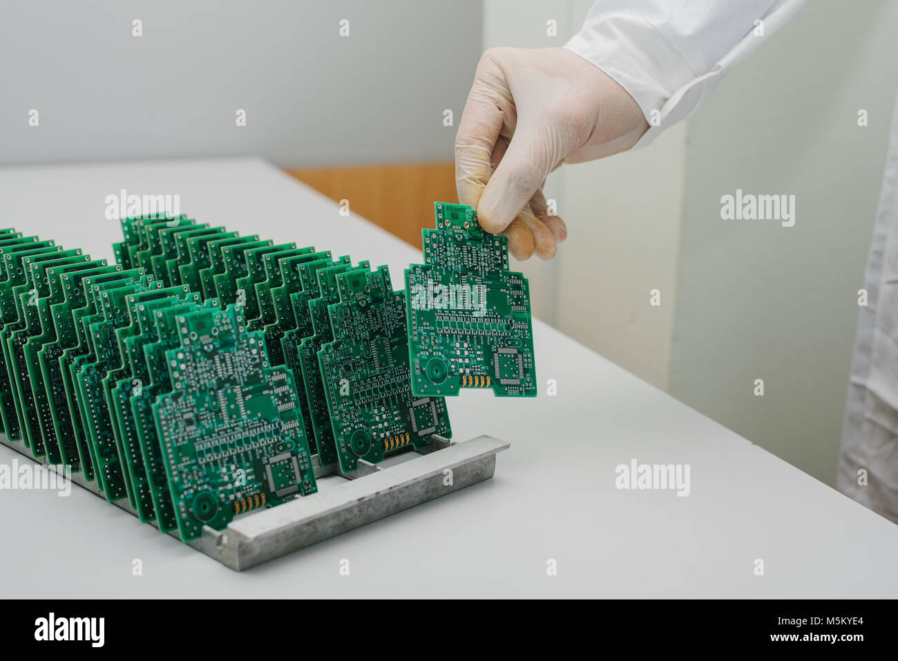 The technician takes a computer board with chips. Spare parts and ...