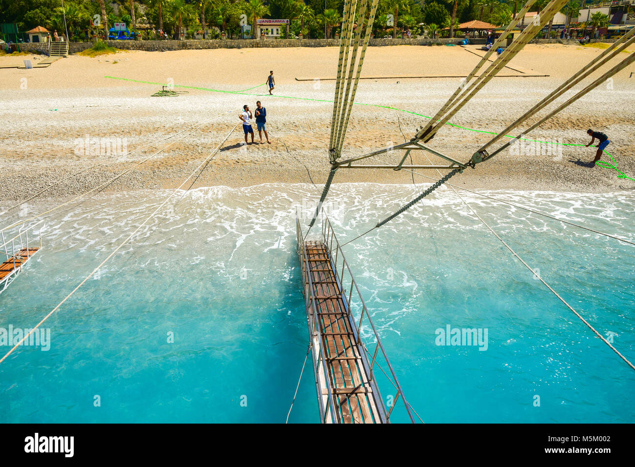 Oludeniz, Turkey - May 11, 2017: Sailing ships for sea excursions in the harbor, movable bridges for tourists to get in and get out from boat. Editori Stock Photo