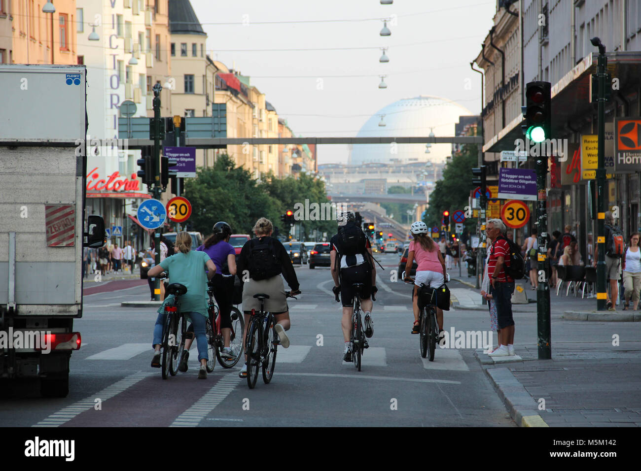 People on bicycles on the street Götgatan on Södermalm in central Stockholm. Stock Photo