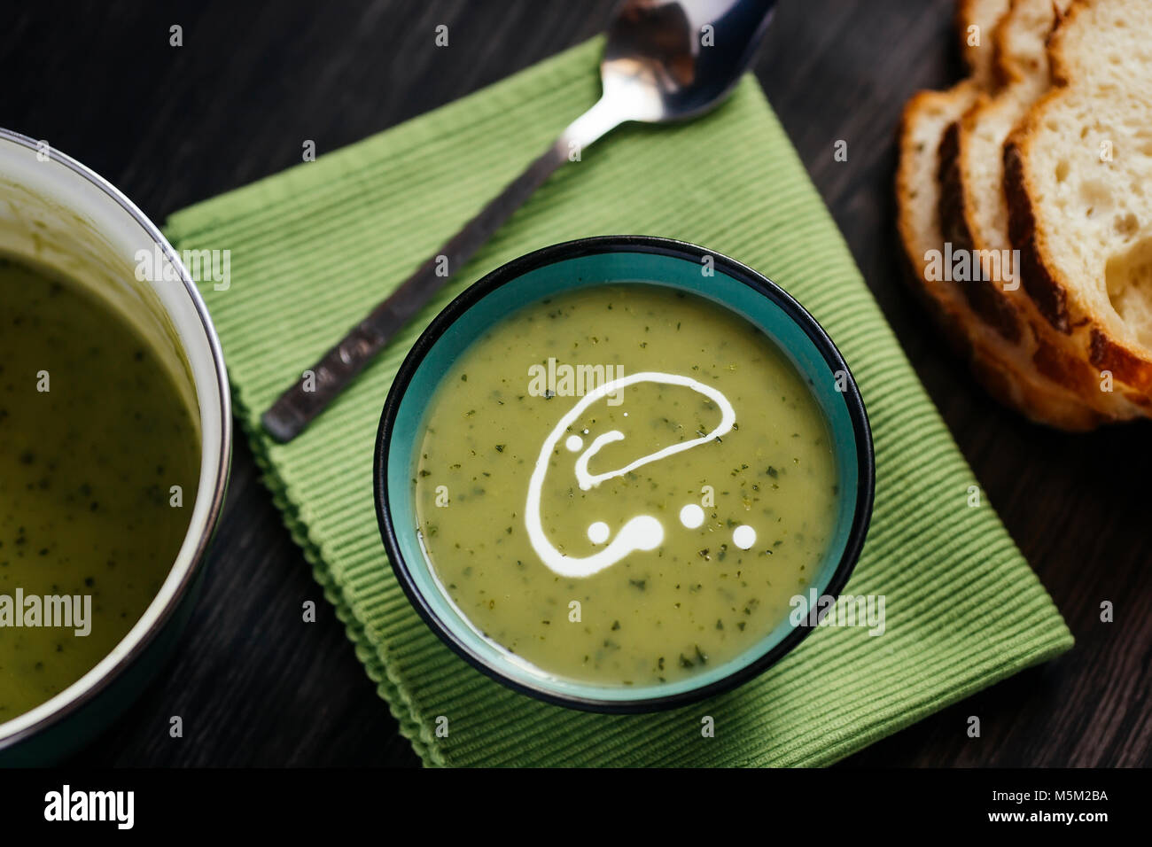 Healthy green soup on a dark wooden table Stock Photo