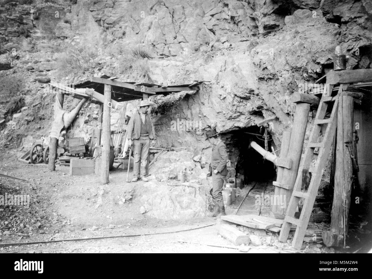 Grand Canyon Historic Grandview Trail . 2 MEN STANDING AT ENTRANCE OF NEW TUNNEL, HORSESHOE MESA COPPER MINE. LEVEL 7. GRANDVIEW CIRCA 1907.. Impressions of the dazzling topography of Grand Canyon have changed and shifted since that day in the summer of 1540 when Garcia Lopez de Cardenas gazed out from the South Rim. The conquistador saw a worthless desert wasteland, nothing more than a barrier to political expansion. At th Stock Photo