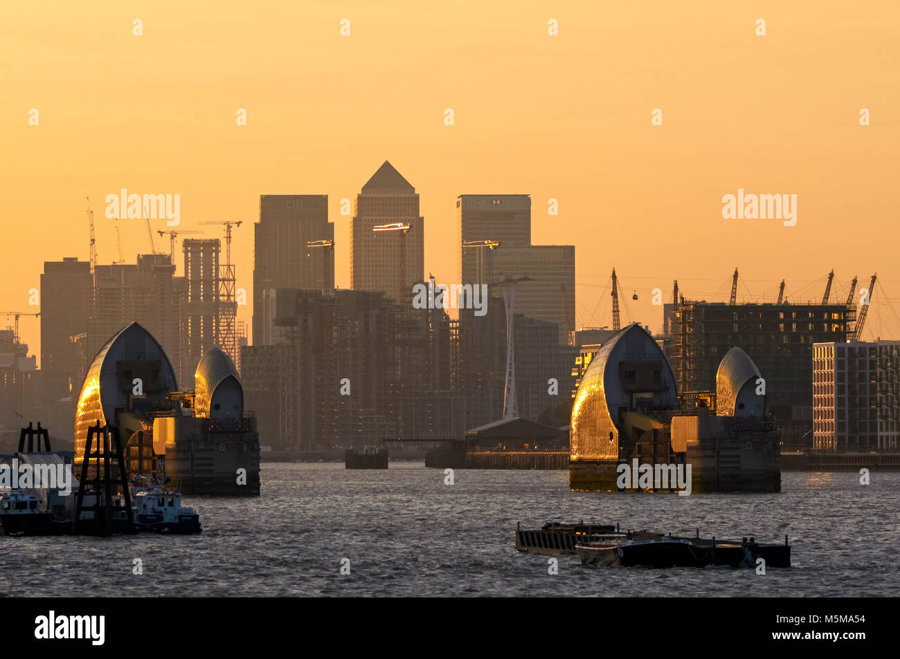 Canary Wharf and Thames Barrier at sunset, London, England, United ...