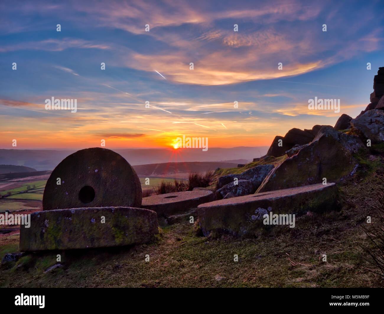 Peak District National Park, Derbyshire, UK. 24th February, 2018. UK Weather: spectacular sunset over the millsones at Stanage Edge near Hathersage, Peak District National Park, Derbyshire Credit: Doug Blane/Alamy Live News Stock Photo