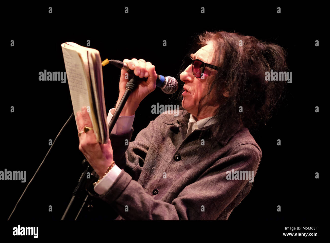 Wyeside Arts Centre, Builth Wells, Powys - Saturday 24th February 2018 - Poet Dr John Cooper Clarke performs live on stage to a full house in Mid Wales with a mix of poems and witty raconteur. Photo Steven May / Alamy Live News Stock Photo