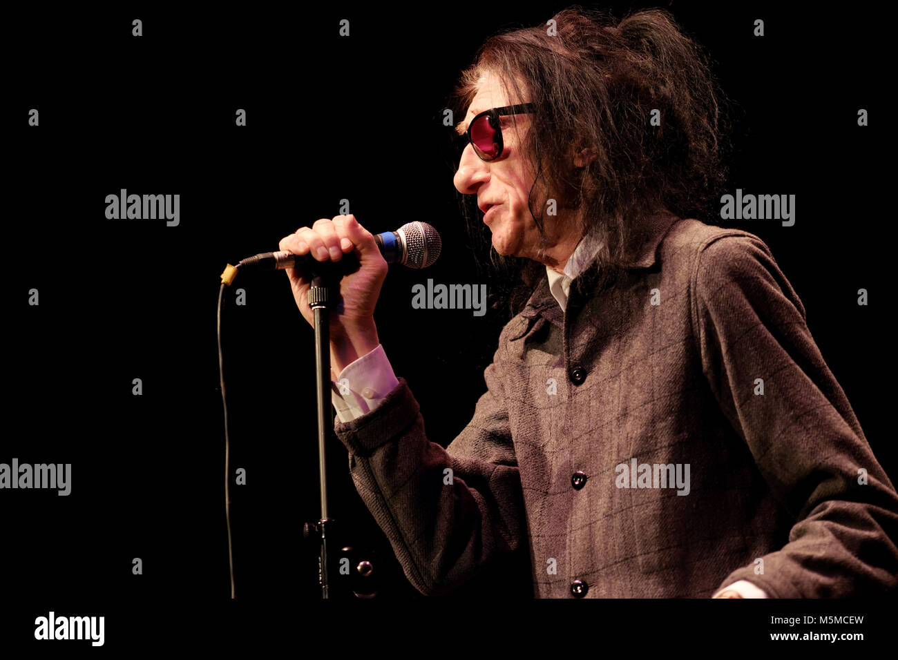 Wyeside Arts Centre, Builth Wells, Powys - Saturday 24th February 2018 - Poet Dr John Cooper Clarke performs live on stage to a full house in Mid Wales with a mix of poems and witty raconteur. Photo Steven May / Alamy Live News Stock Photo