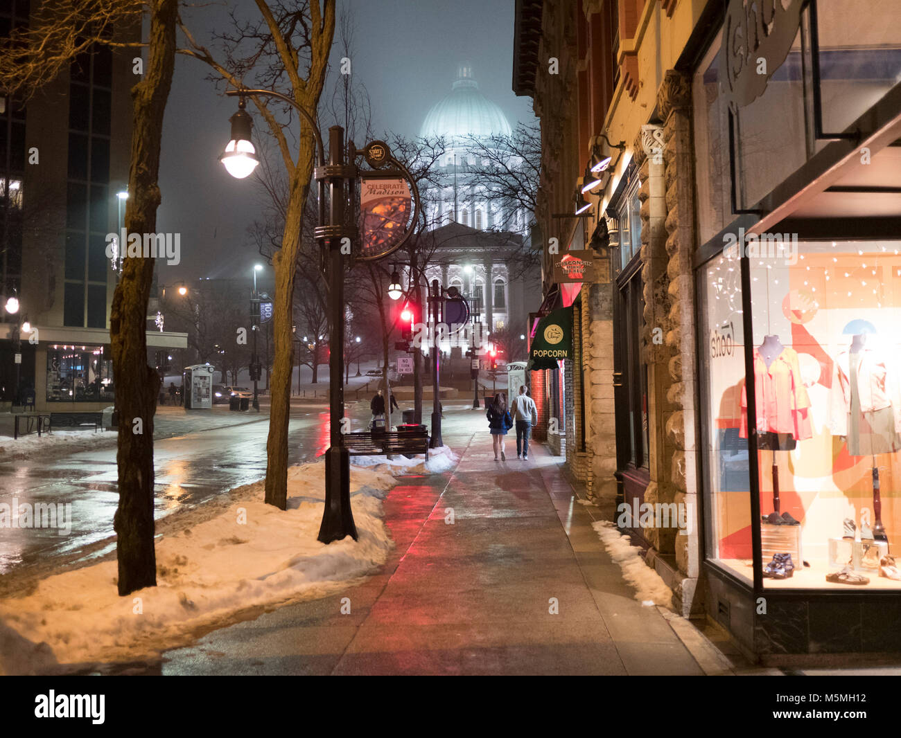 Young couple strolling along State Street on Valentines night. Madison