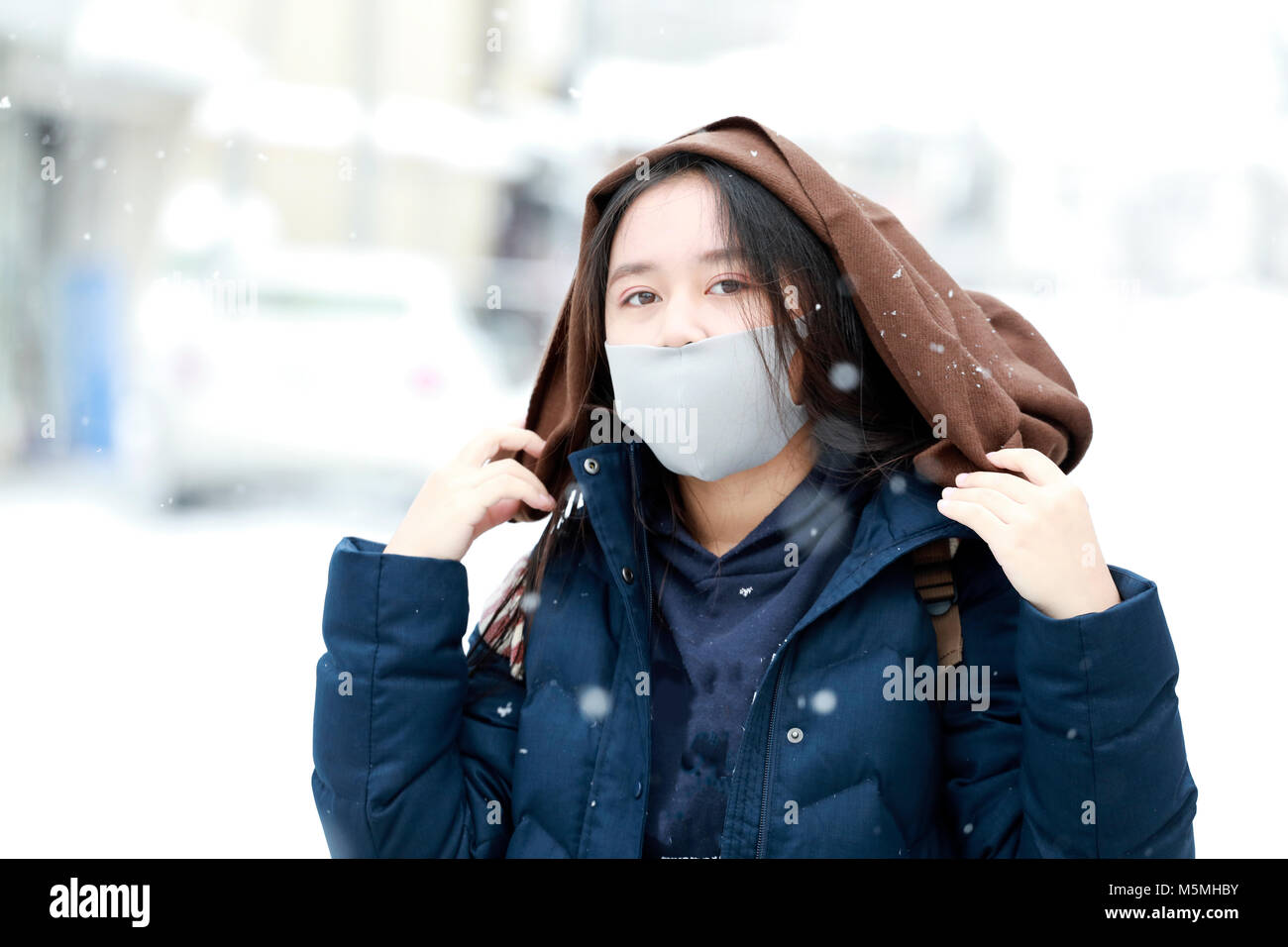 girl teenage on the snow day enjoying herself on a cold winter day in Japan Stock Photo