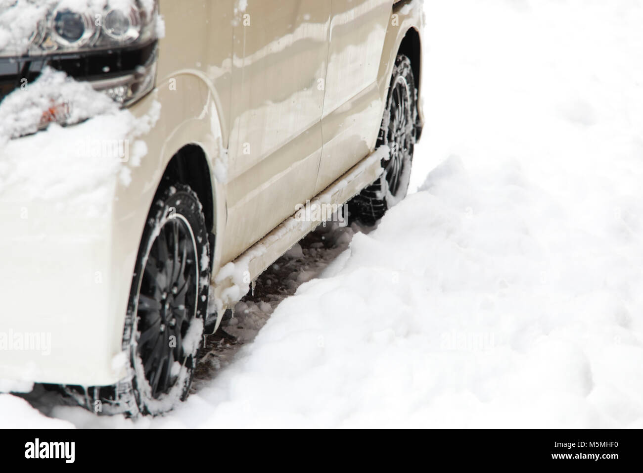 snow ice on tire,car tires on a snow,Frozen ice build up wheel fender arch. Driving problems. Extreme winter snow series. Close up tire on the snowy r Stock Photo