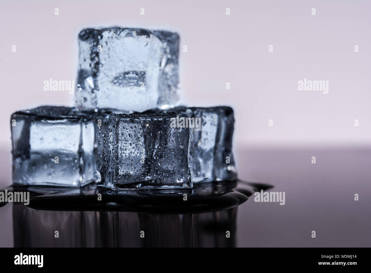 Many ice cubes on black reflection background Stock Photo