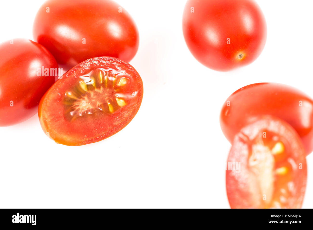 Little cherry tomatos isolated on white background Stock Photo - Alamy
