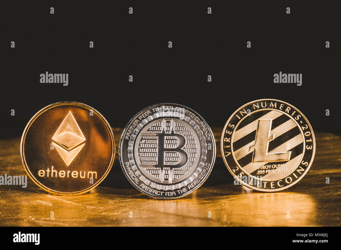 Cryptocurrency litecoin,Silver Bitcoin,Ethereum on golden floor and black  background,Digital cryto currencies.Virtual money Stock Photo - Alamy
