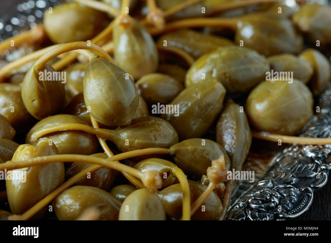 Pickled caper berries . Edible fruits of Capparis . Berries are used as