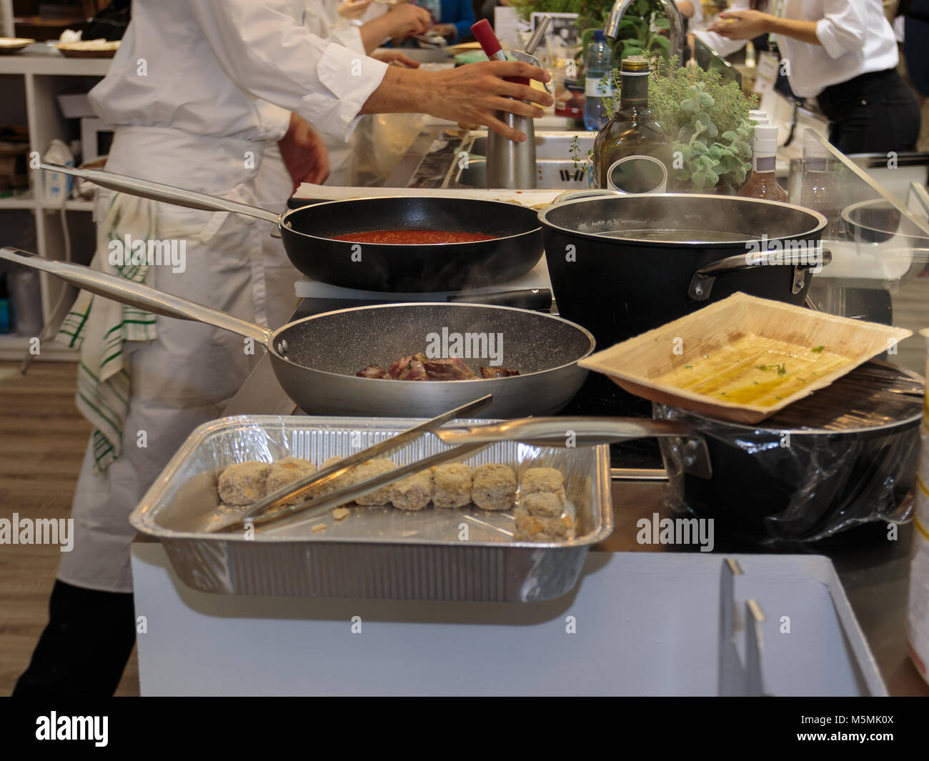 Cooking inside Restaurant's Kitchen, Pans and Chef with Uniform Stock