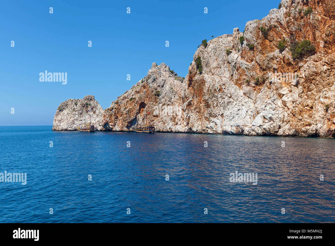 The coast of the sea. Beautiful cliffs over the blue, view from the sea. The unusual landscape. rocks and the sea of Alanya Stock Photo