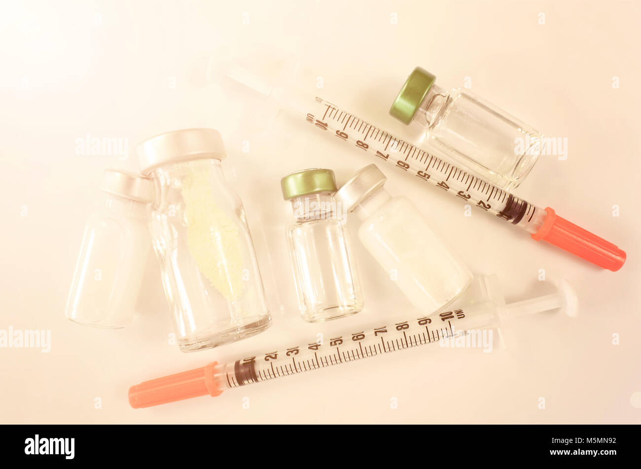 Injection pharmaceutical dosage form on white background with warm light tone. Stock Photo