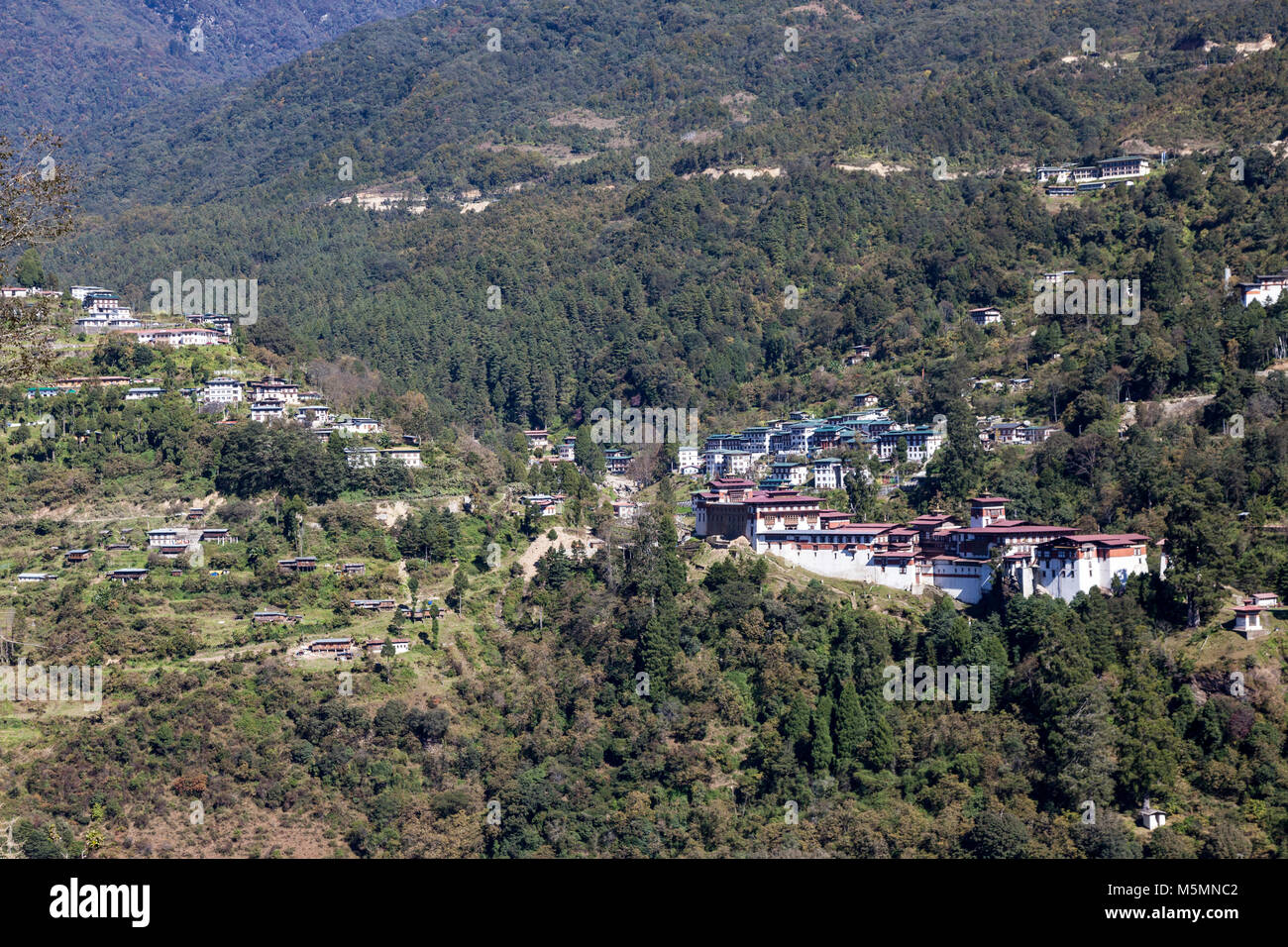 Trongsa, Bhutan.  Trongsa Dzong (Monastery-Fortress)in Foreground Right. Trongsa Town in background. Stock Photo