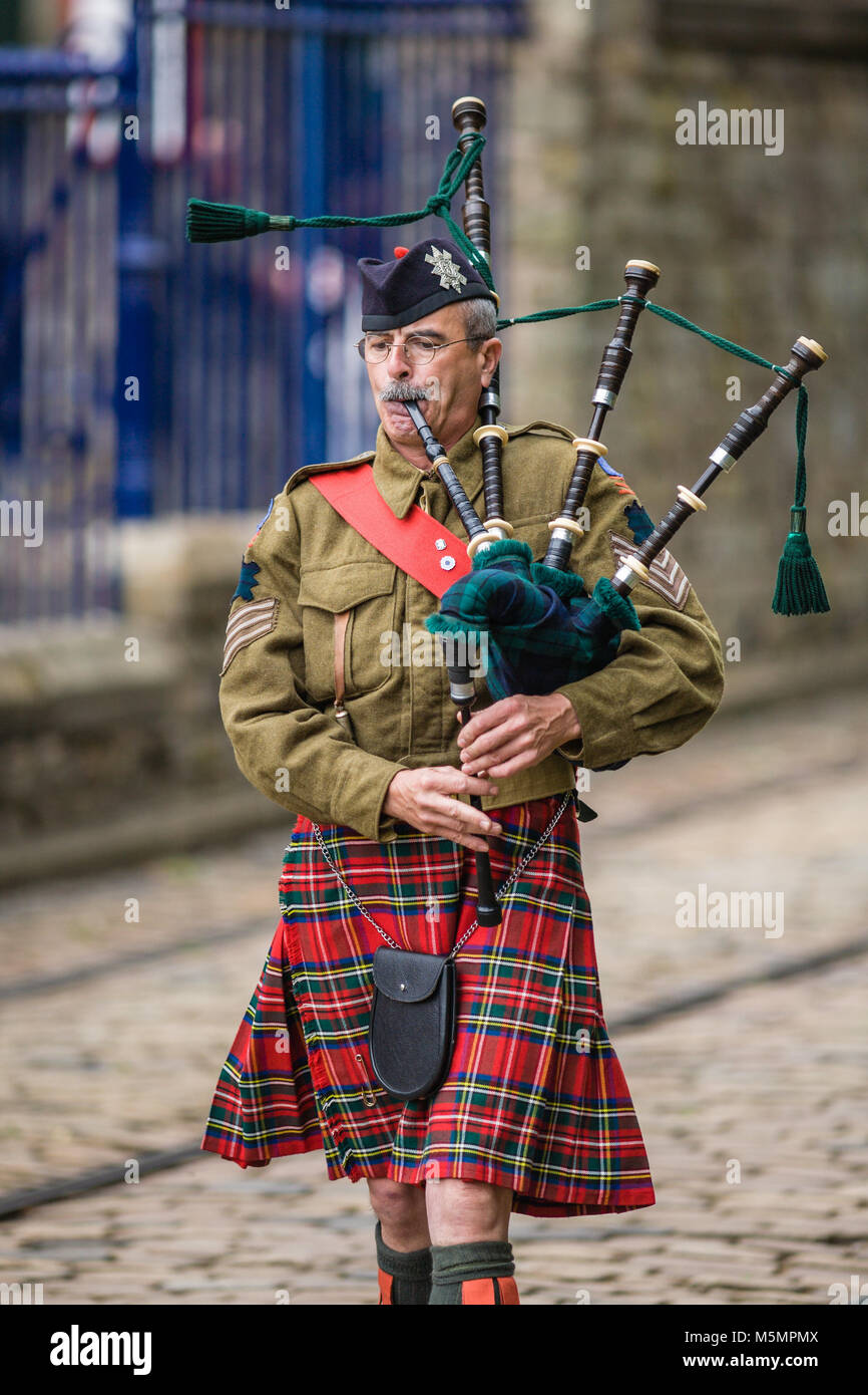 A Kilted Piper Leads the Parade at  the1940s Re-enactment Weekend at the National Tramway Museum, Crich, Derbyshire, England, UK Stock Photo