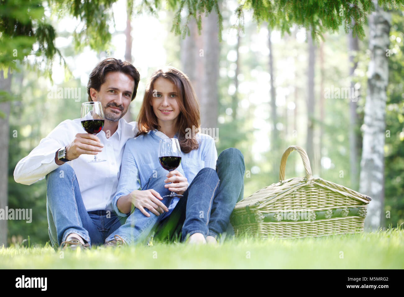 Young beautiful couple on picnic in summer park Stock Photo - Alamy