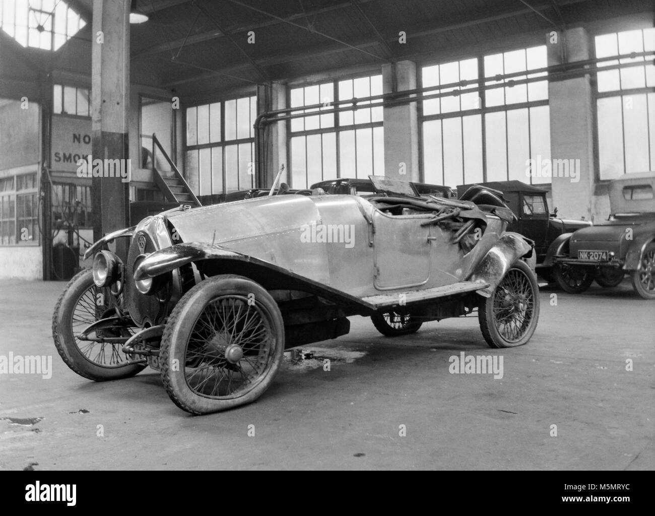 Vintage Bugatti Type 23 Brescia car, licence number XU 8943, in a garage after an accident. Photo taken in the UK around the 1920s. Stock Photo