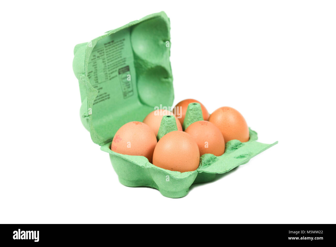 A dozen large eggs in green egg box insulted white background Stock