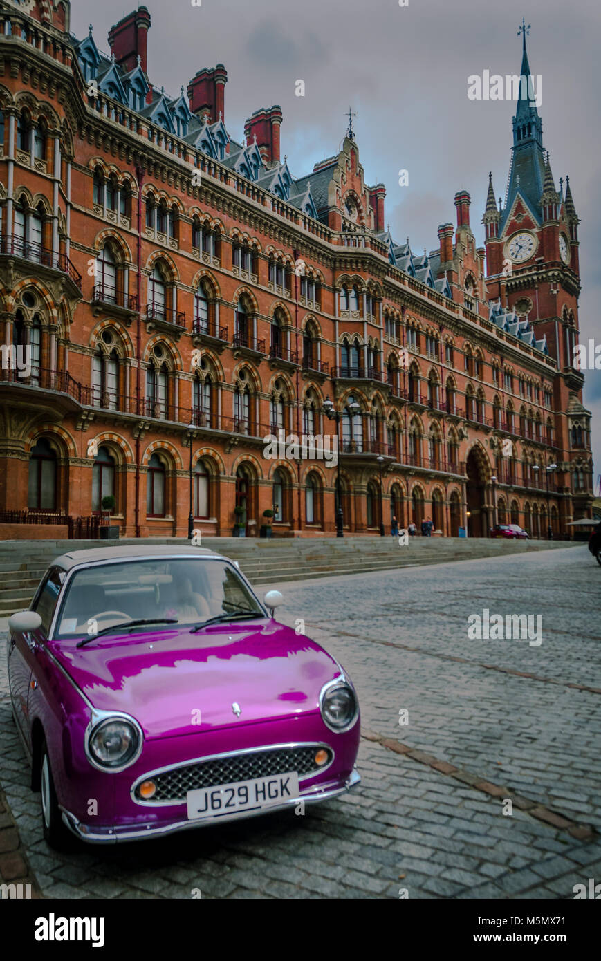 Vintage car outside of St Pancras international hotel and rail station Stock Photo