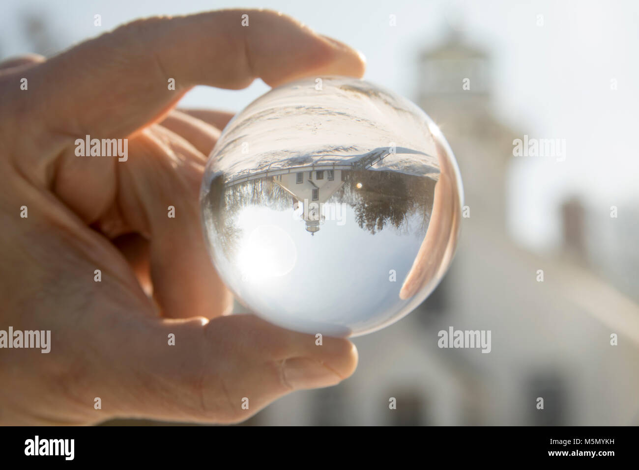 Crystal ball reflecting exterior of Old Mission Lighthouse in Traverse CIty, Michigan in winter. Stock Photo