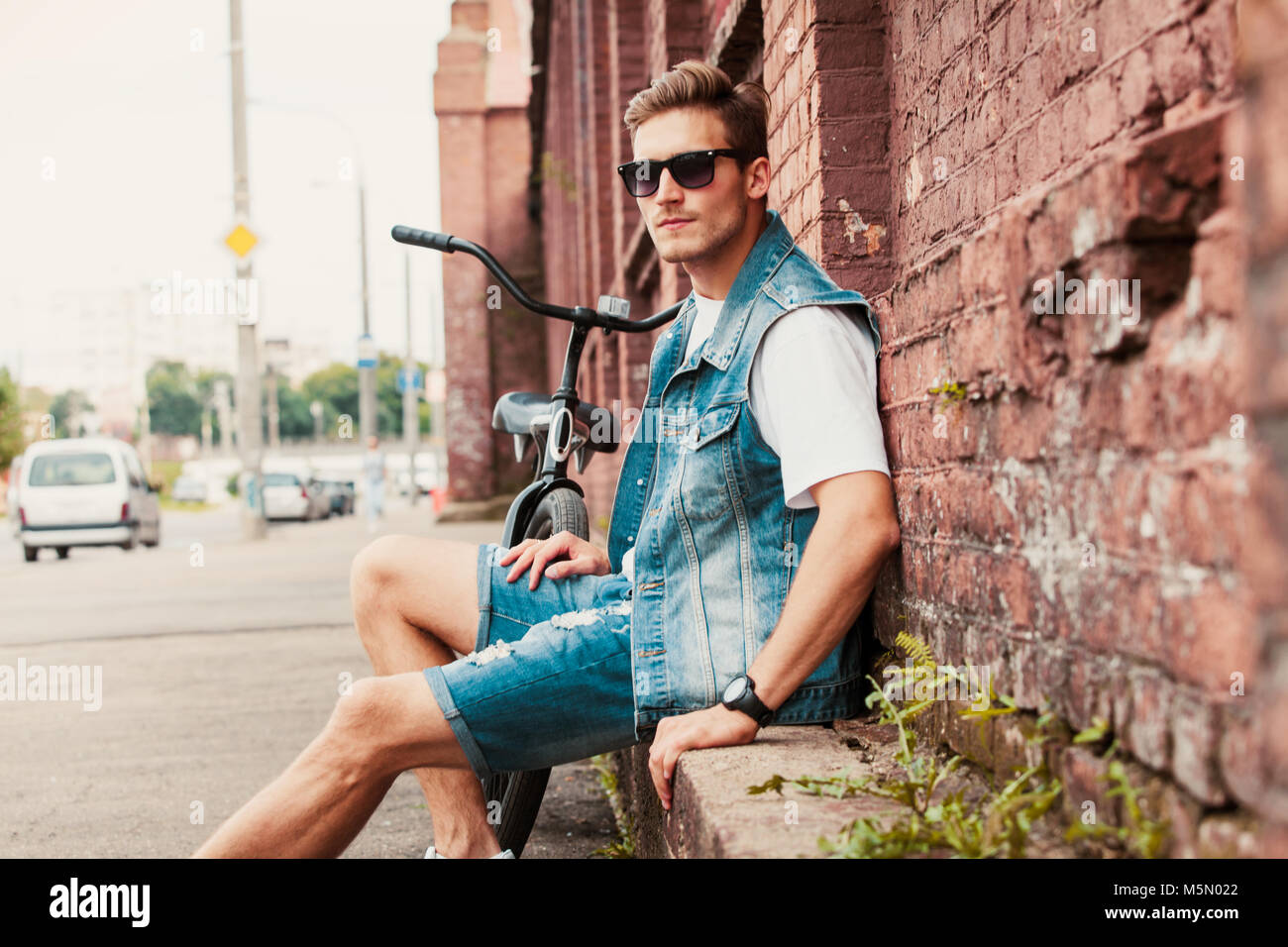 portrait of a trendy young man in the city Stock Photo - Alamy