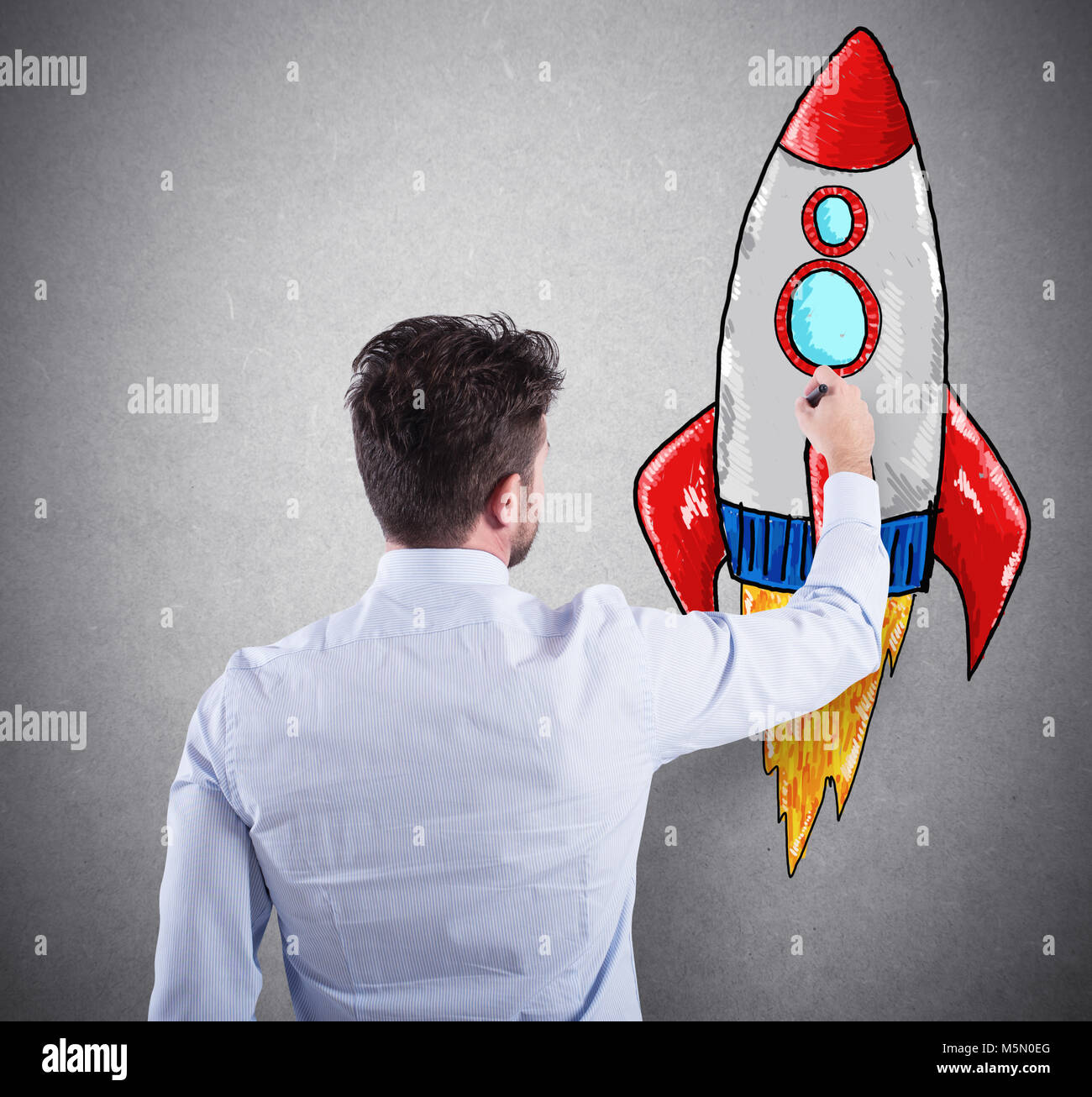 Businessman drawing a rocket. Concept of business improvement and enterprise startup Stock Photo