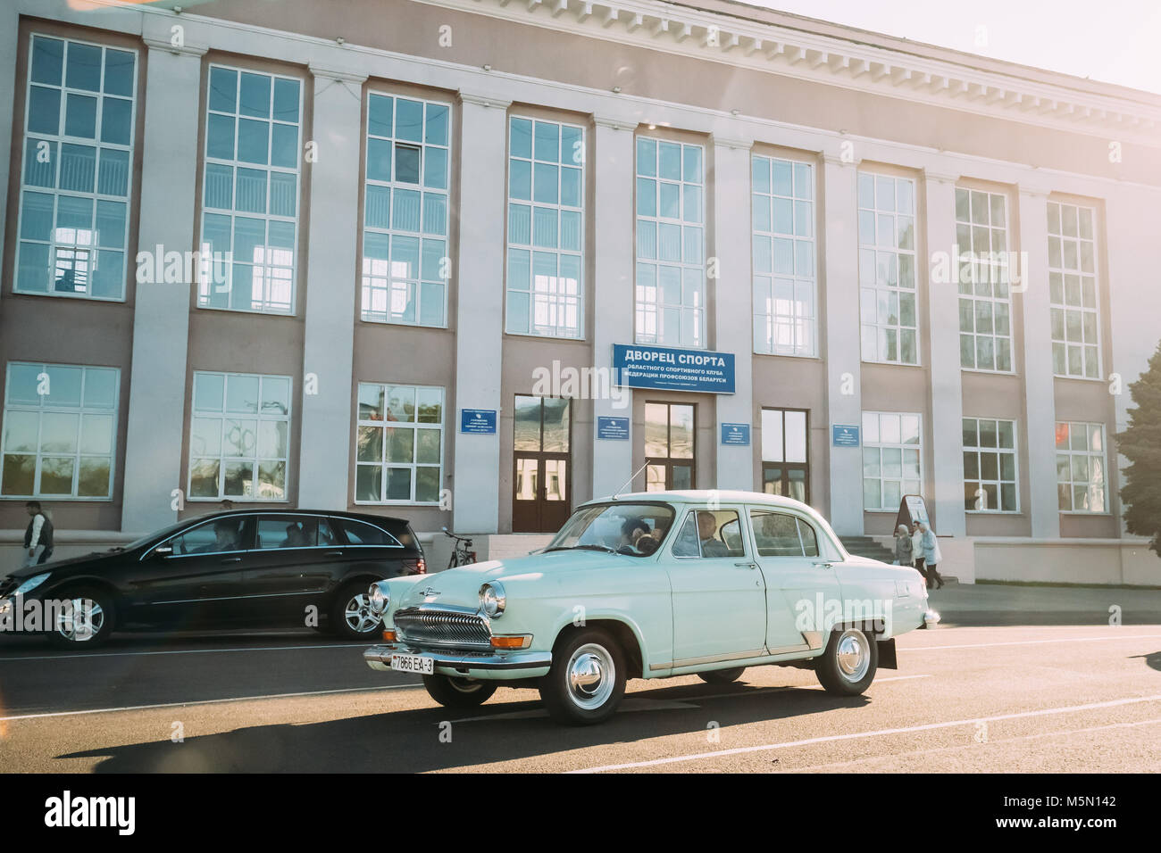Gomel, Belarus. Old Retro Gray Volga GAZ-21 Car Moving On Lenina Street. Stock Photo