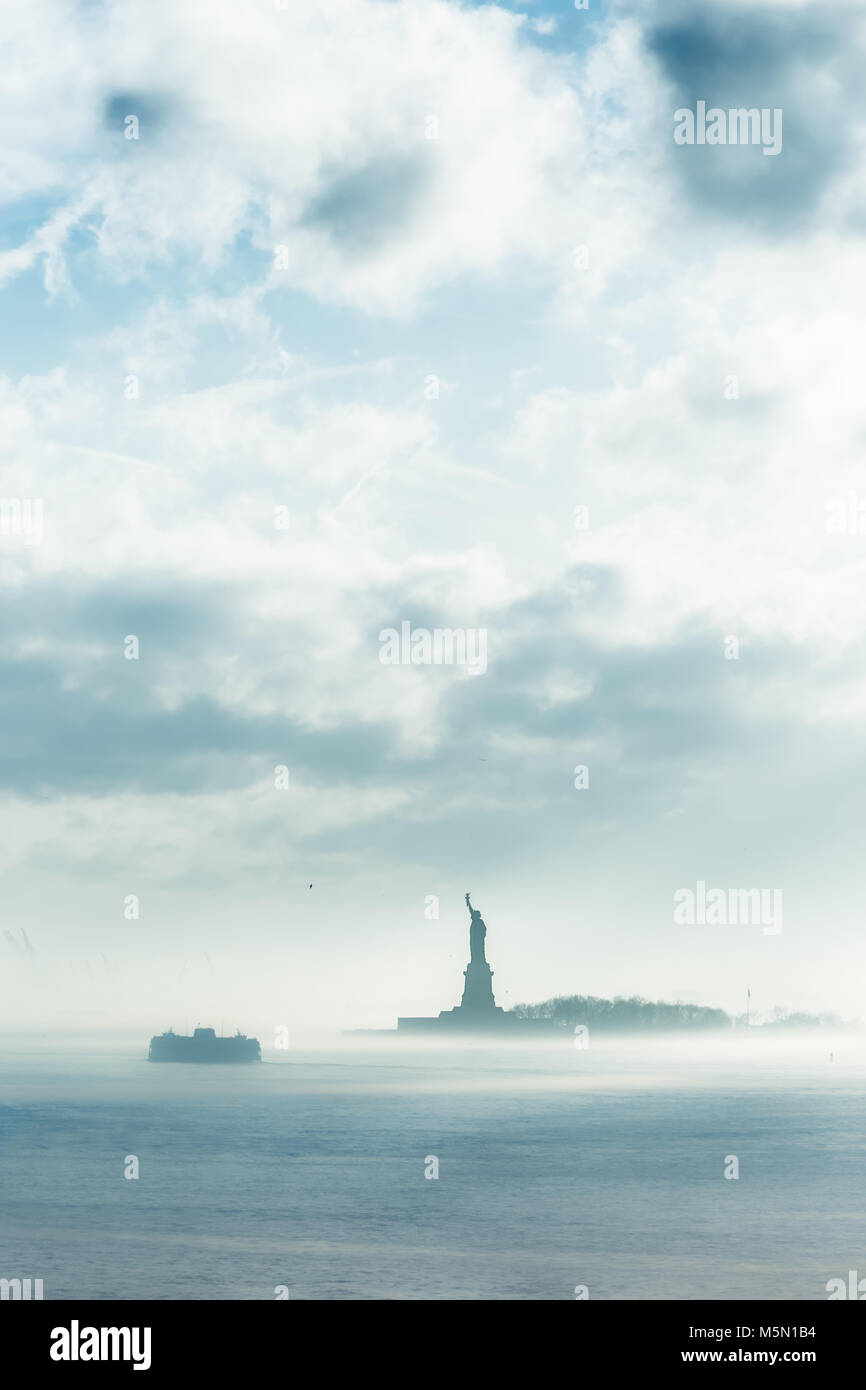 Staten Island Ferry cruises past the Statue of Liberty in dramatic