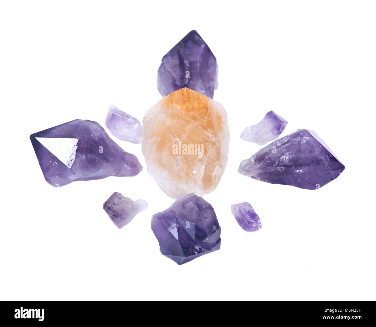Amethyst and citrine natural points arranged in crystal grid isolated