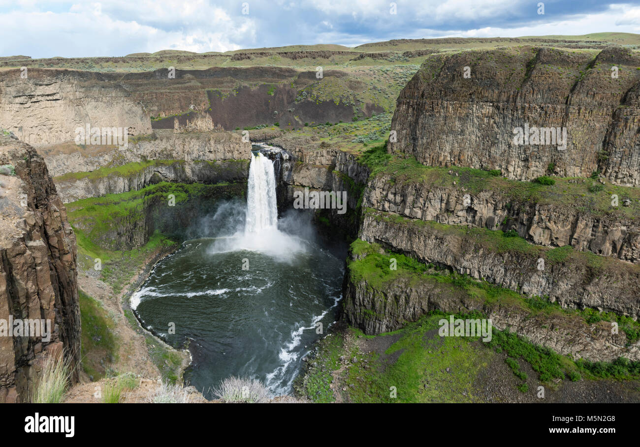 Palouse Falls is on the Palouse River about 4 miles upstream from its confluence with the Snake River in Eastern Washington.  The falls are 198 feet in height and drop into a canyon created by the Missoula flood in ancient times. Stock Photo