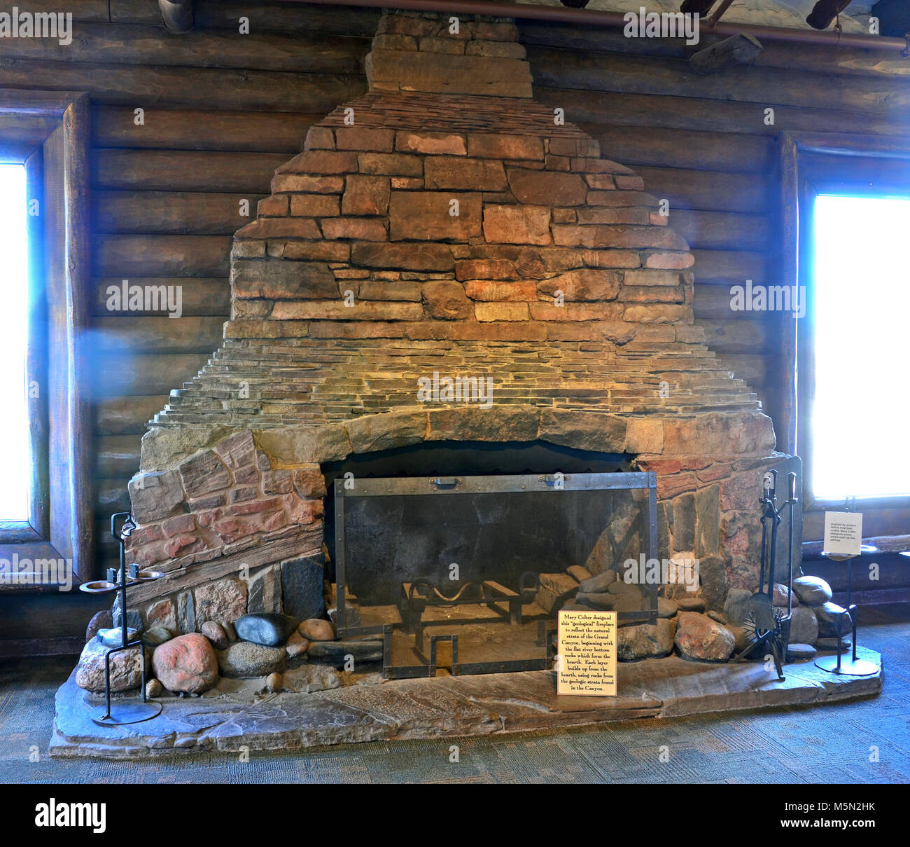 Grand Canyon National Park Geologic Fireplace  . The Bright Angel Lodge (1935) History Room features the work of Santa Fe Railroad's architect Mary Colter. Take a closer look at the room’s stone fireplace. Notice how its’ tall, sloping outlines mirror the temples seen within the canyon. Known as the “Geologic Fireplace,” it’s a classic example of Colter’s  artistic sensibility and her extraordinary attention to detail.    The layere Stock Photo