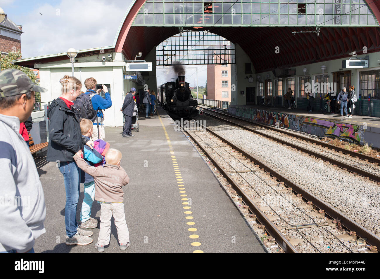 Steam engine running into the train station of Nørrebro in Copenhagen Stock Photo