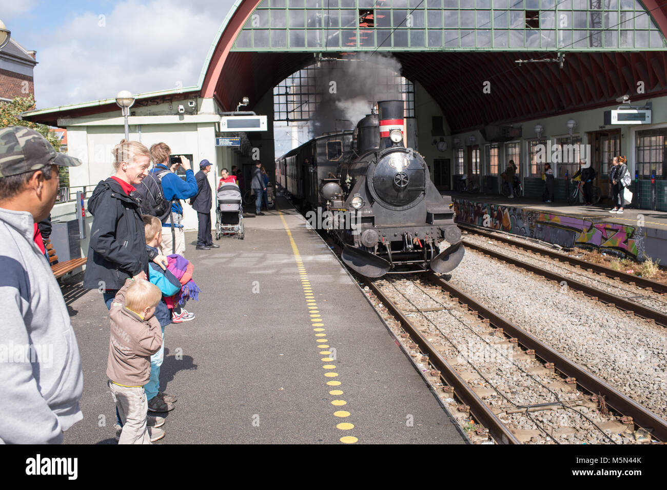 Steam engine running into the train station of Nørrebro in Copenhagen Stock Photo