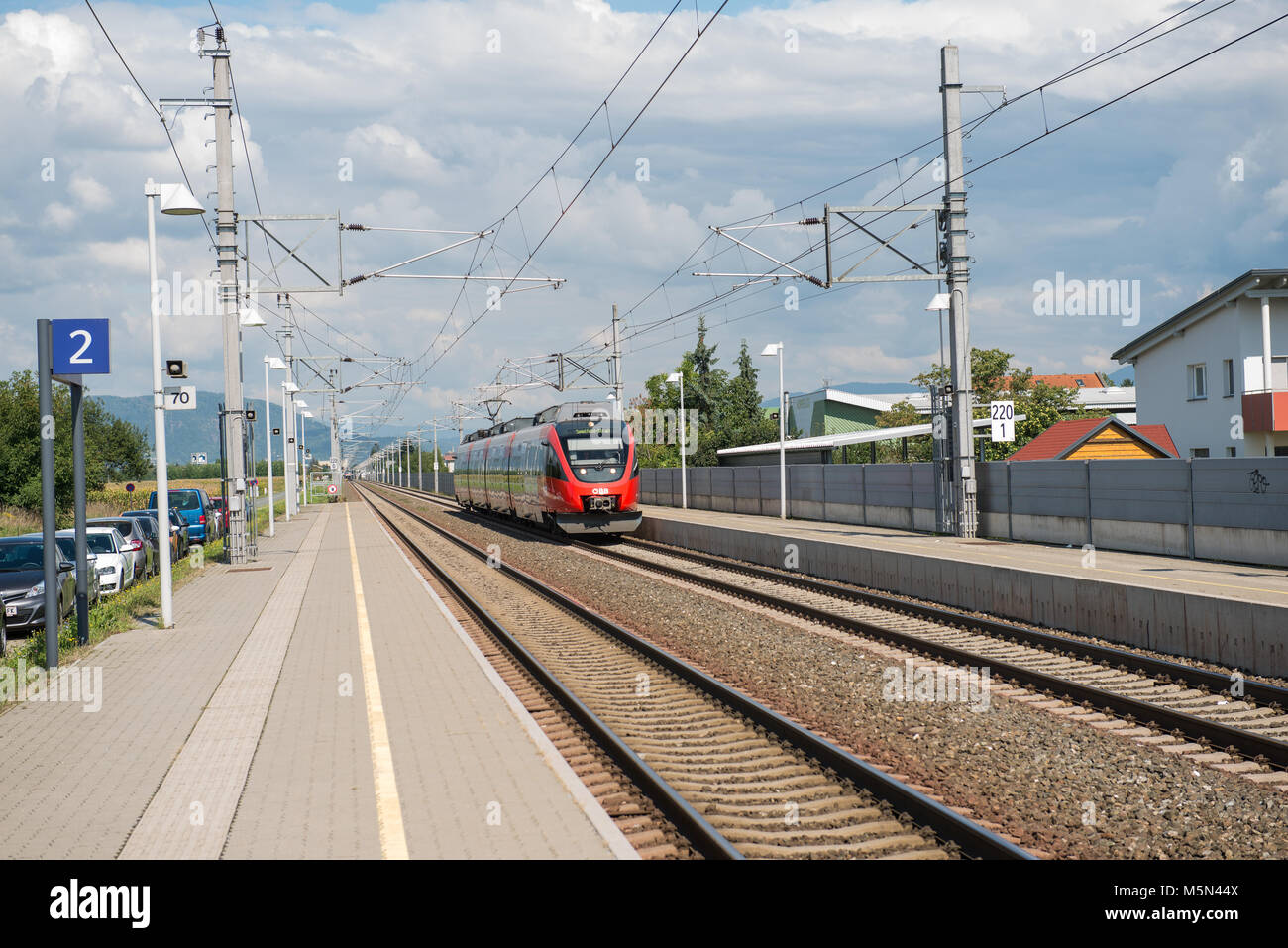 Train tracks and station at Flughafen Graz Feldkirchen with perron Stock Photo