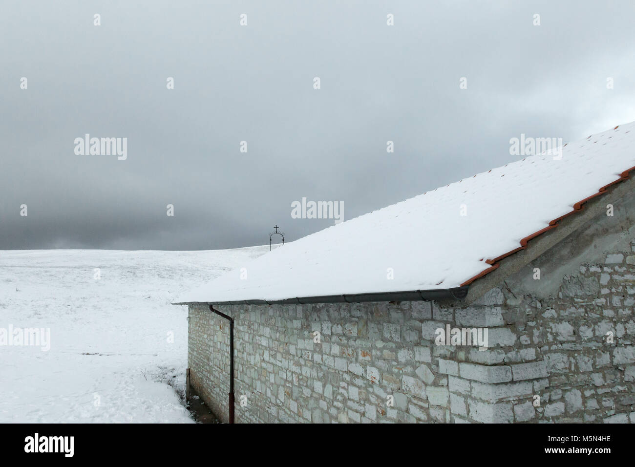 A small mountain retreat covered by snow on Mt. Subasio (Umbria, Italy) during winter season Stock Photo