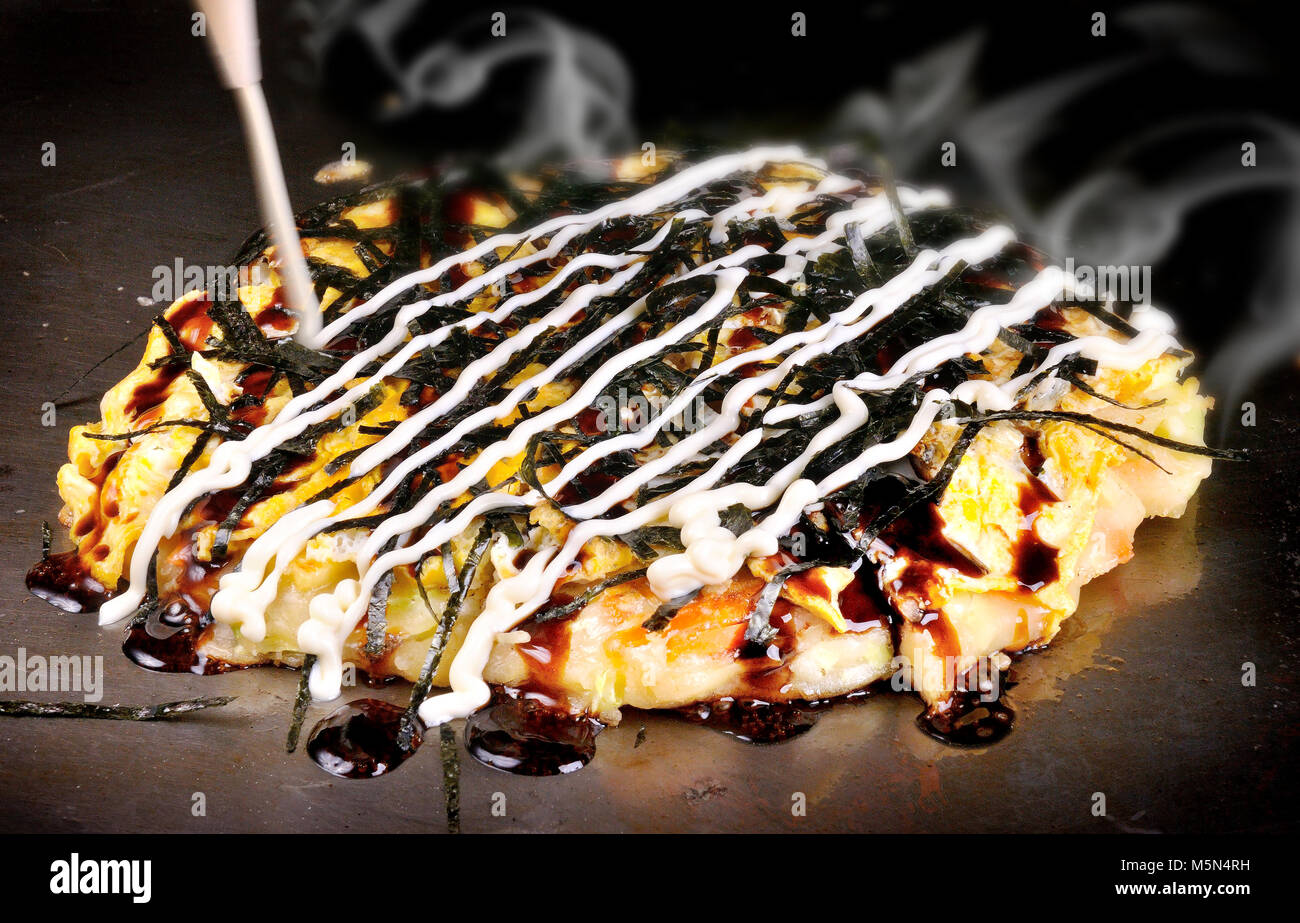 Japanese Okonomiyaki is japanese pizza great and yammy Stock Photo