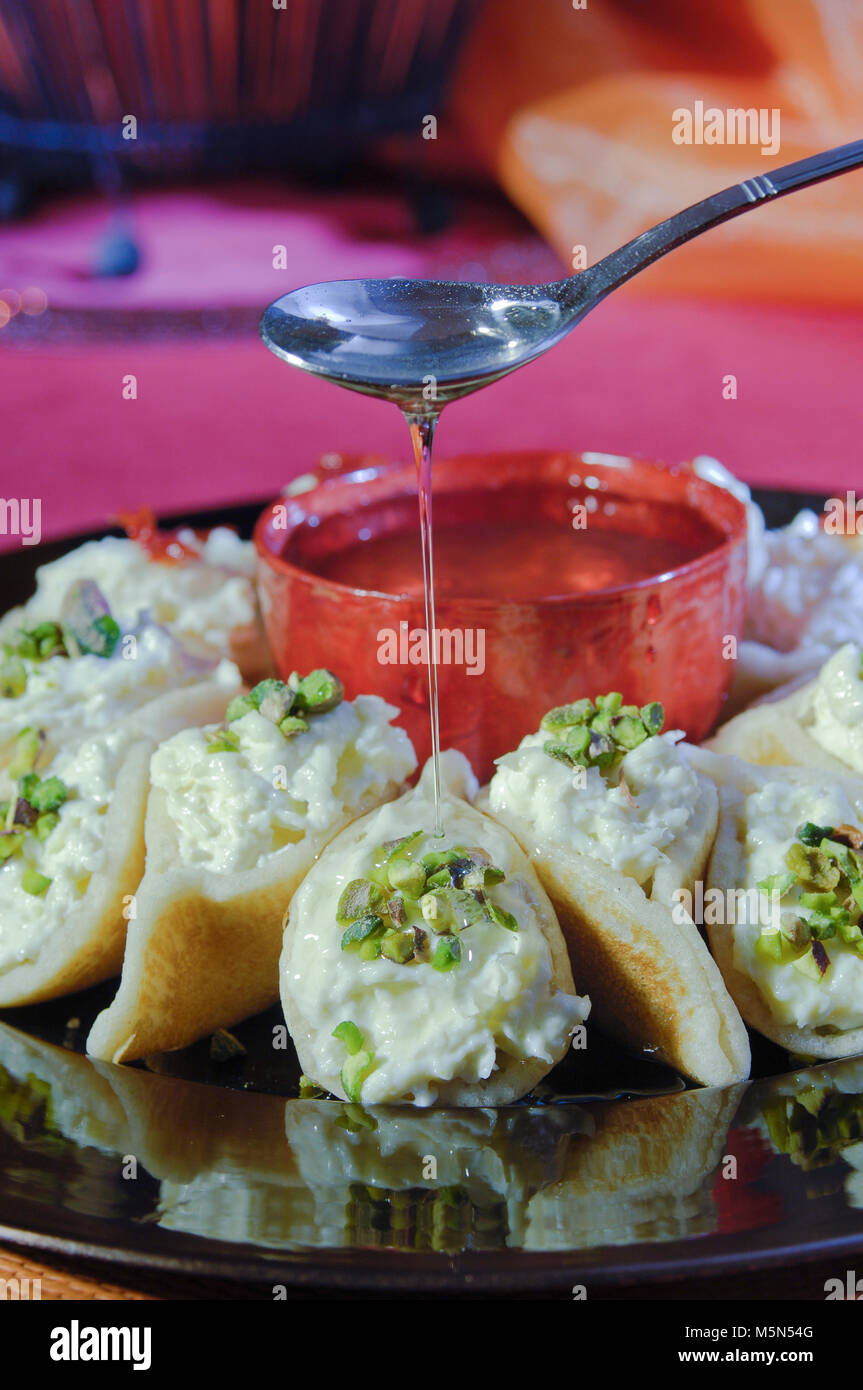 Pouring Syrup on Asafeer, Arabic Sweets with Cream for Ramadan and Eid