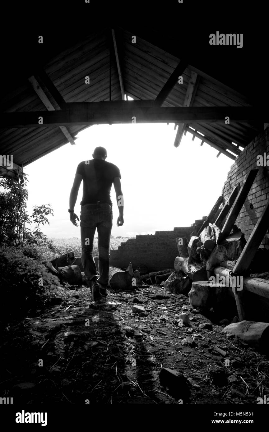 Location Portrait Photography of a male in a derelict barn. Photographer Claire Allen Stock Photo