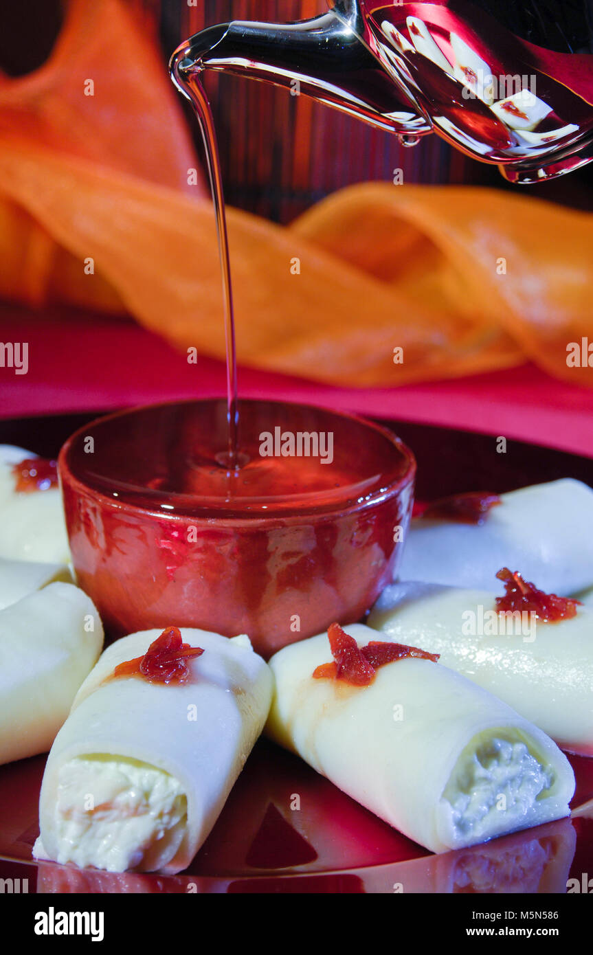 Pouring Syrup on Halawa Jubon, Arabic Sweets with Cream for Ramadan and