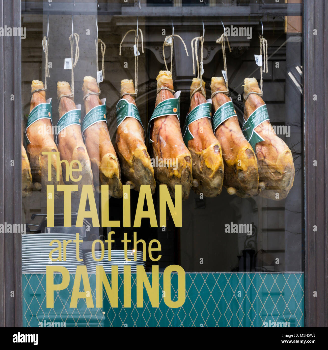 Parma hams hanging in the window of Panino Giusto in Royal Exchange Buildings in the City of London. Stock Photo