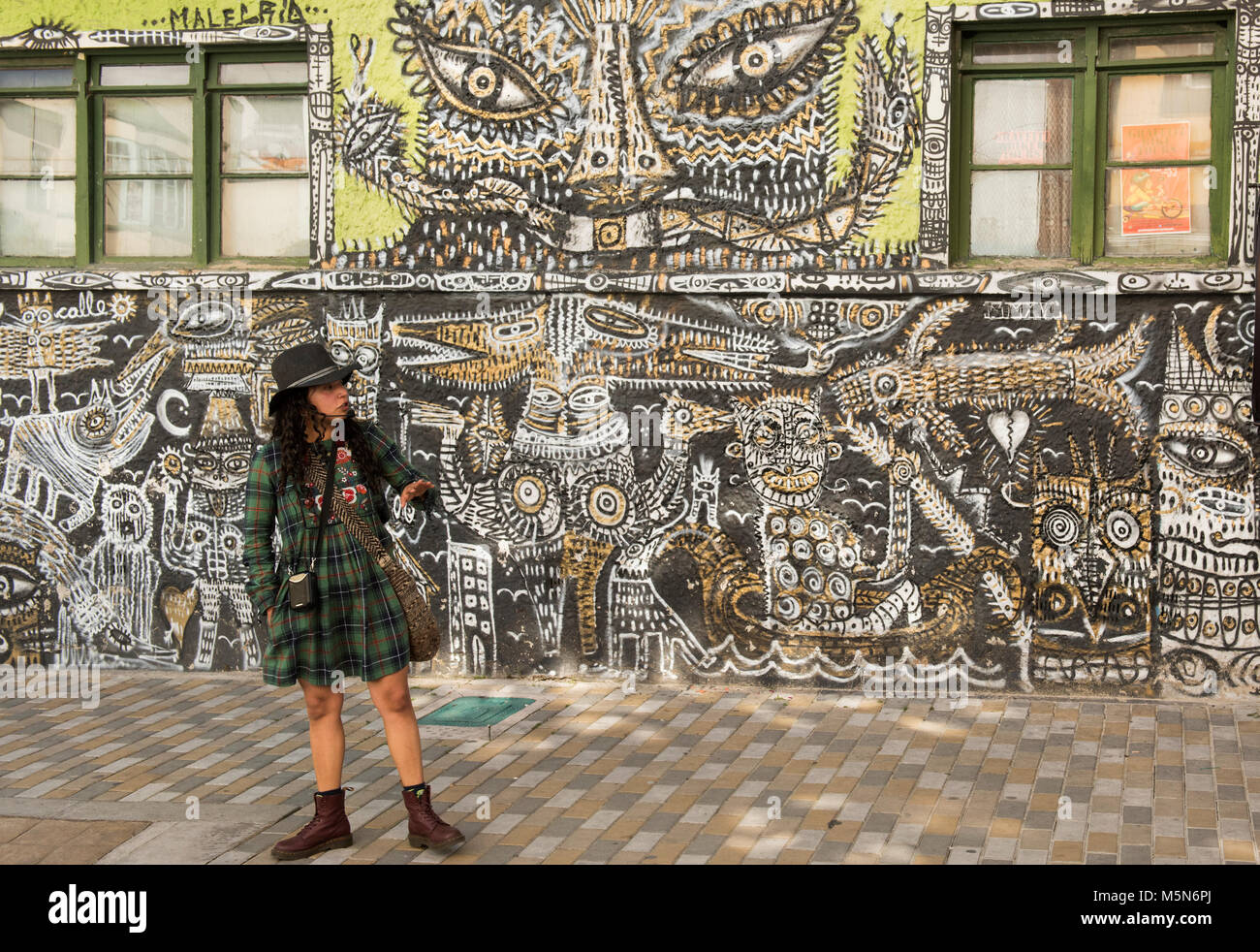 A very popular guide to the graffiti of Bogota, Colombia, addresses her audience of mainly tourists. Stock Photo