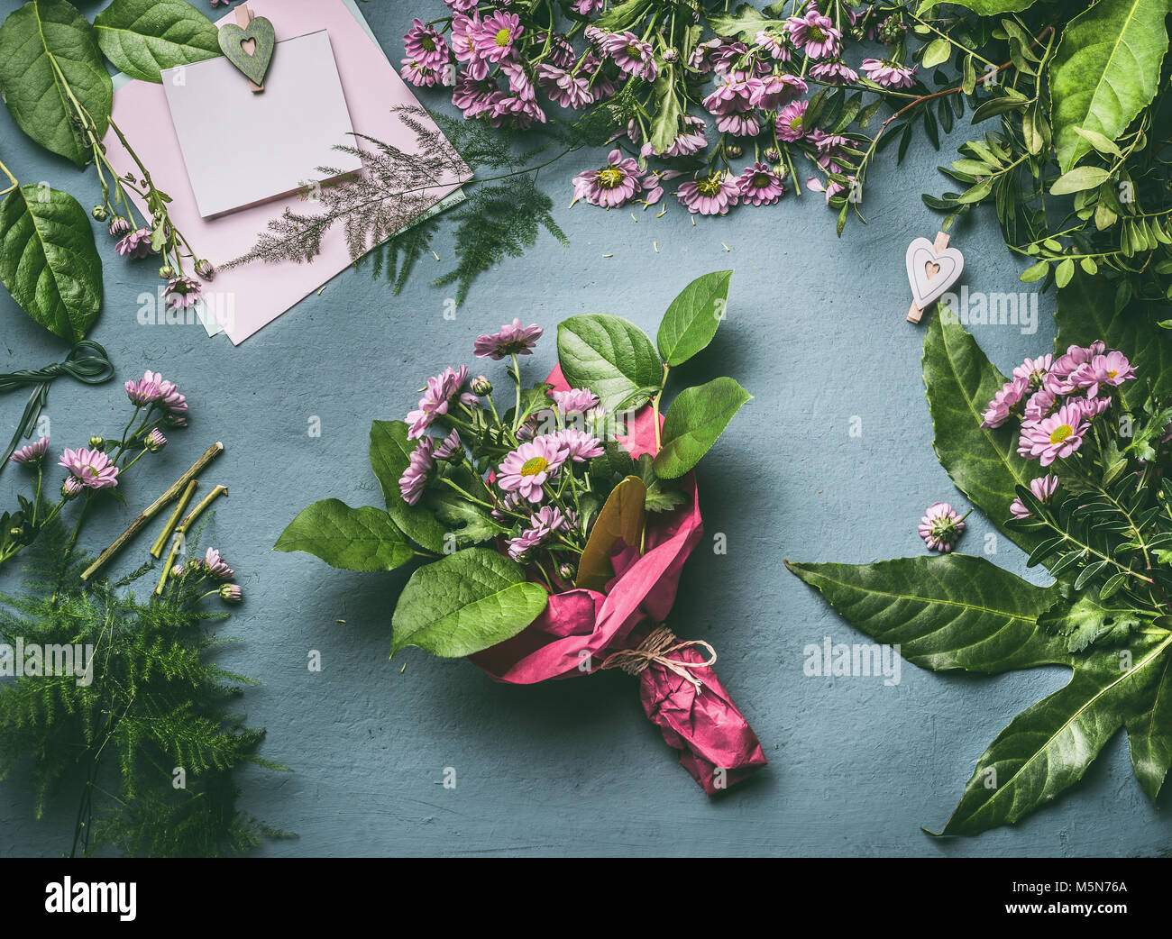 Download Desk Table With Bouquet Of Flowers Wrapped In Red Wrapping Paper Florist Workspace With Various Flowers Decoration And Greeting Card Mock Up Top Stock Photo Alamy
