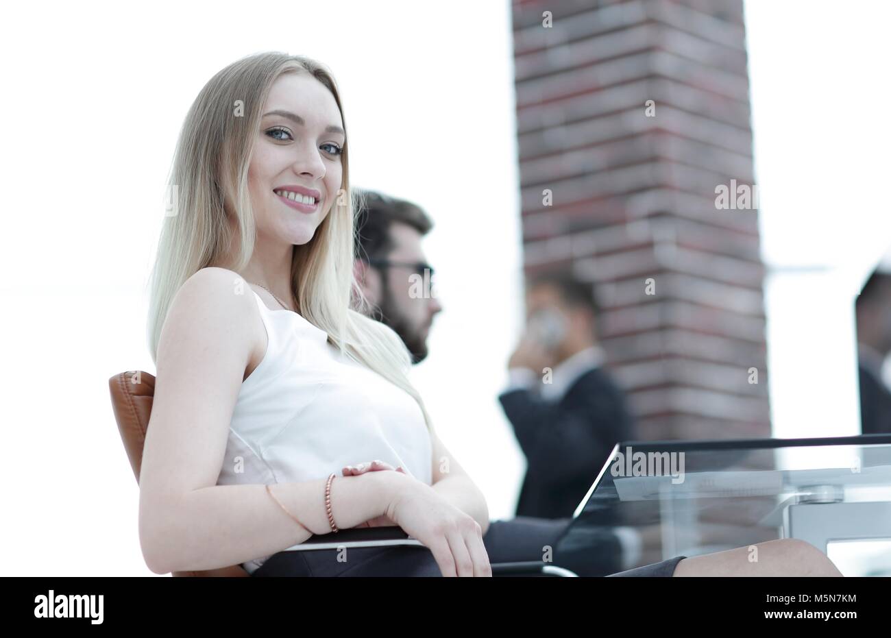 young business woman sitting at a desk in the office Stock Photo - Alamy