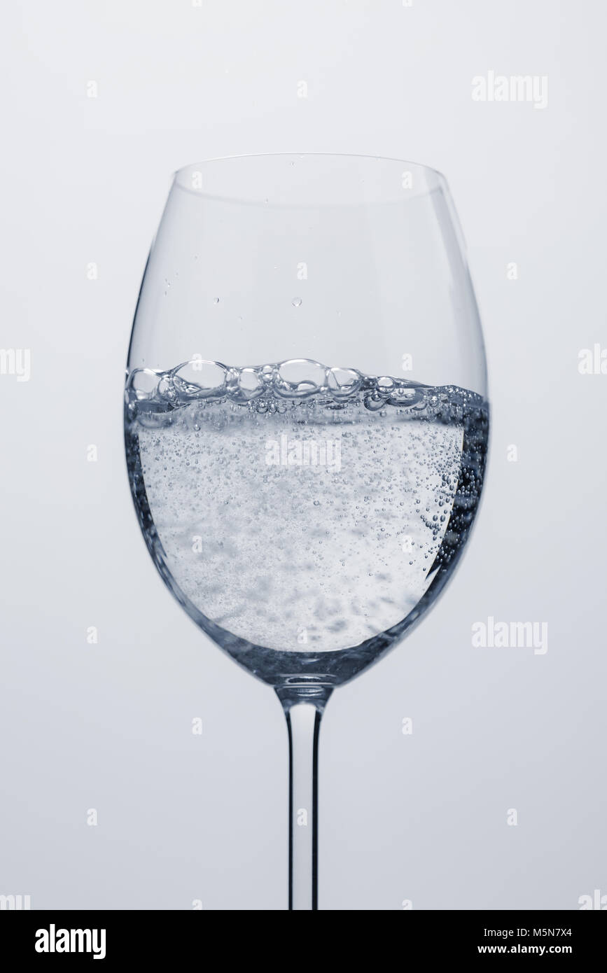 poured mineral water in wine glass, closeup Stock Photo