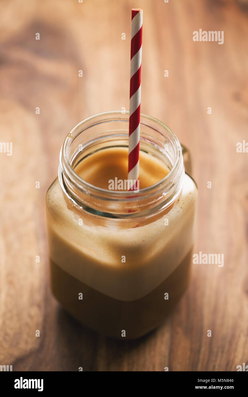 Iced coffee in jar, mug glass cup on the white table Stock Photo - Alamy