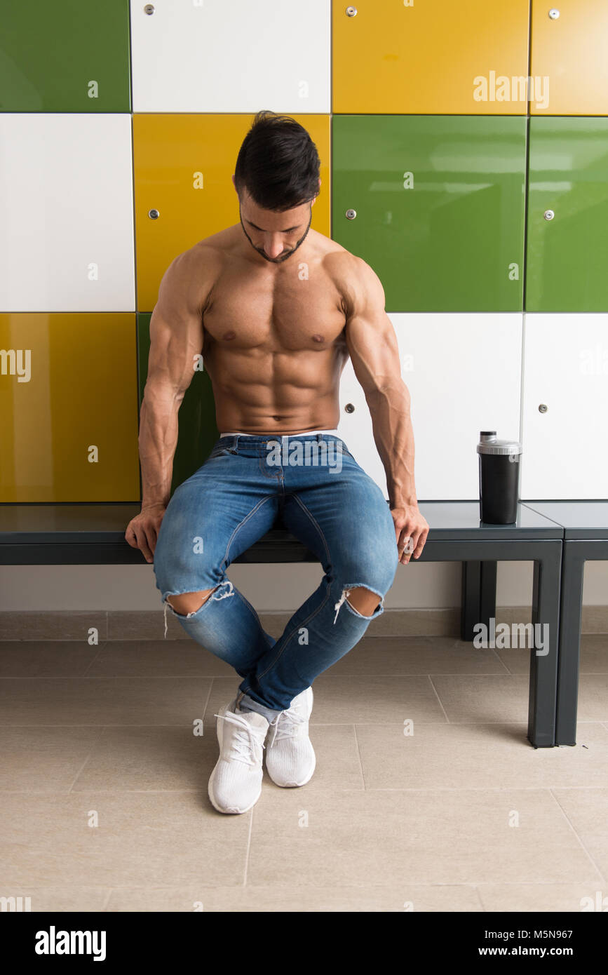 Young Man Resting In Gym Dressing Room With Supplements Shaker for Copy  Space - a Place for Your Text Stock Photo - Alamy