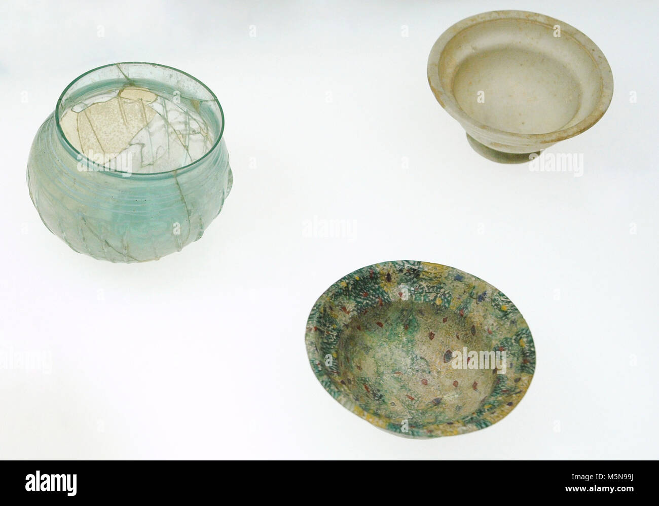 Corrugated shell, from Cologne; Bowl of Millefiori, probably from Rhineland and glass container, unknown origin. Roman-Germanic Museum. Cologne. Germany. Stock Photo